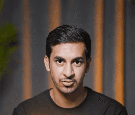 Silhouetted profile of a person in a turtleneck against a teal background. Soft lighting creates a dramatic and contemplative mood.