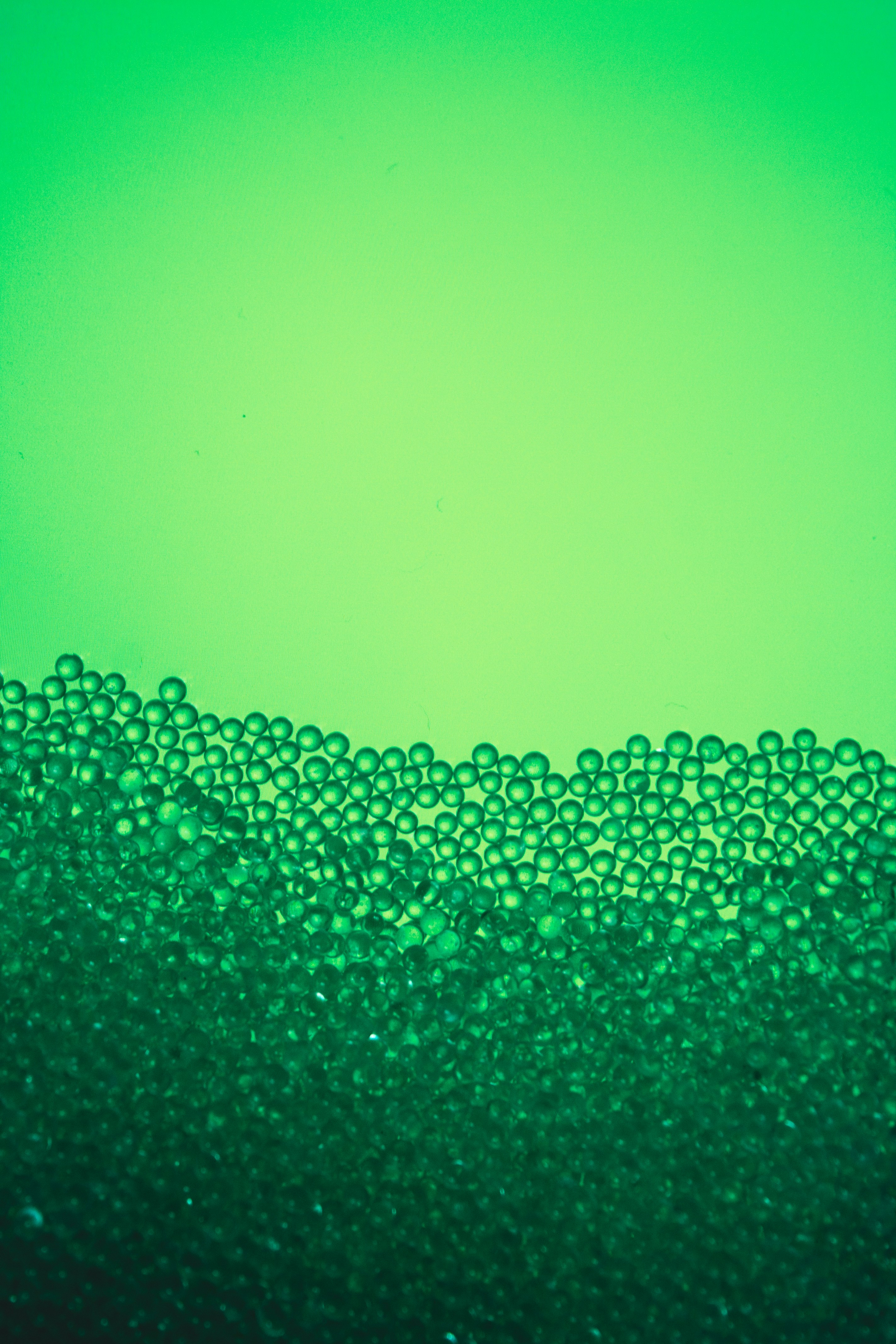 a close up of a green liquid filled with bubbles