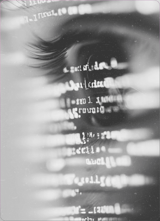 Young man in a white shirt and dark jacket against a plain background.