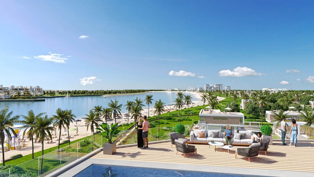 Aerial view of Dubai Islands showcasing luxury villas, pristine beaches, and vibrant blue waters under a clear sky.