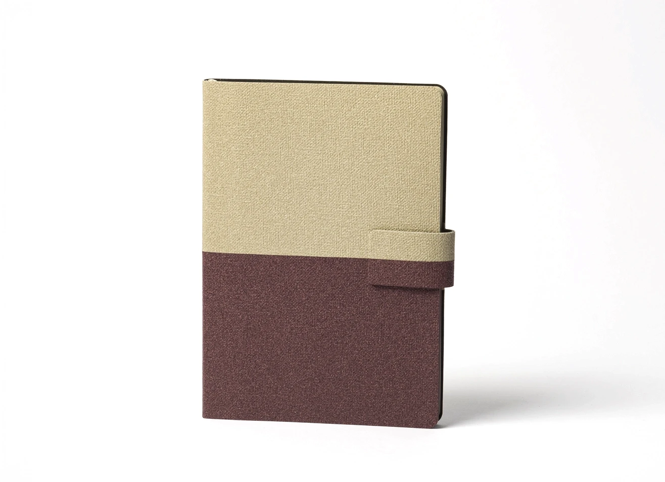 Front view of beige and maroon fabric notebook with strap.
