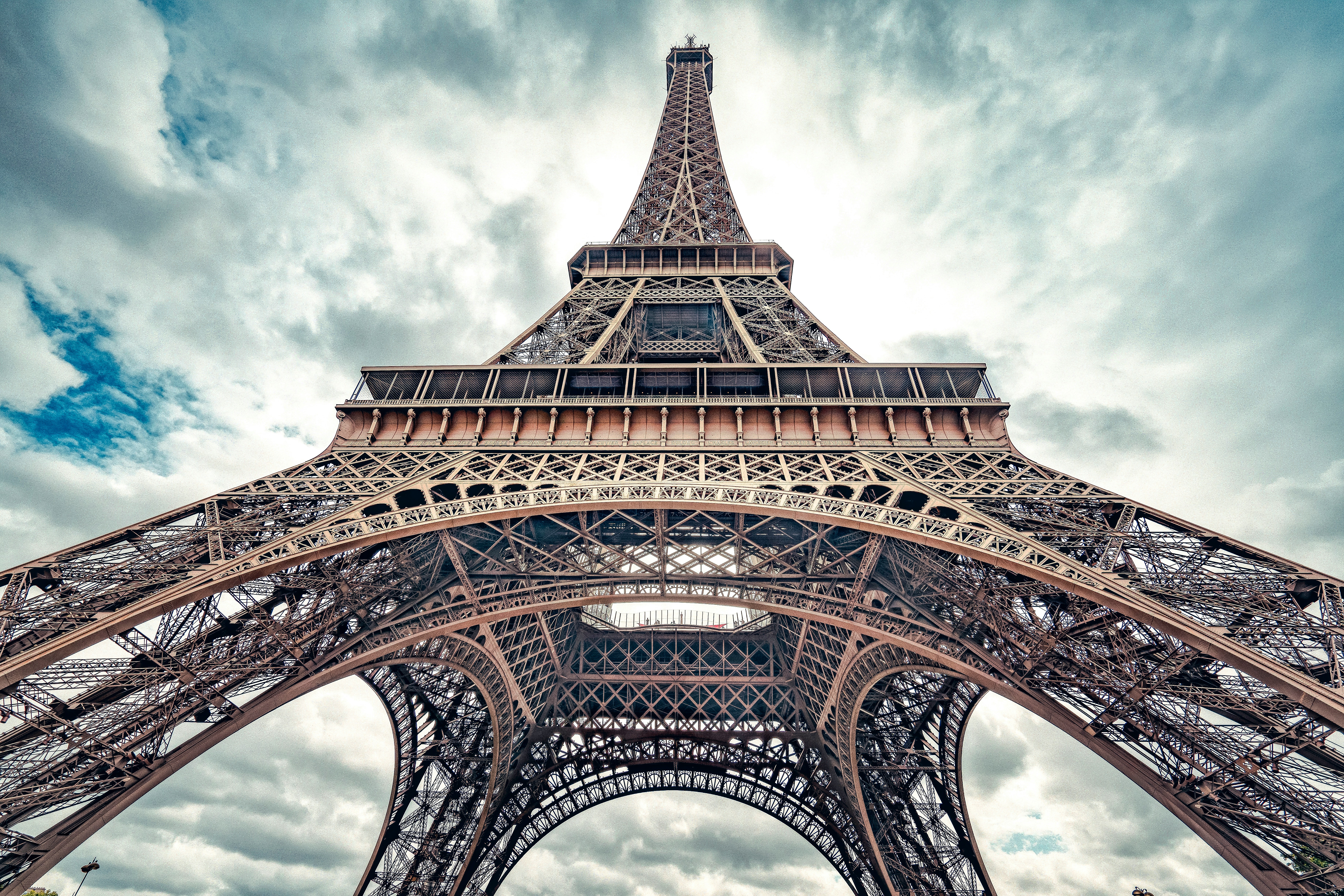 a tall metal tower with Eiffel Tower in the background