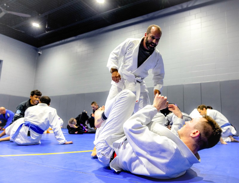 Students working on guard passing in brazilian jiu jitsu class