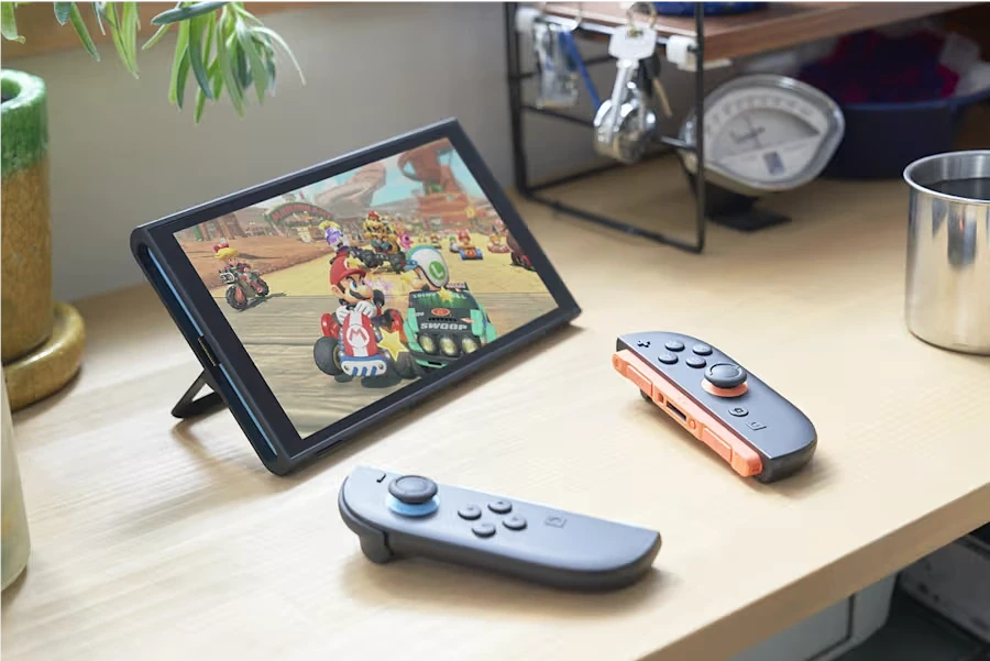 Portable game console sitting on table with two controllers