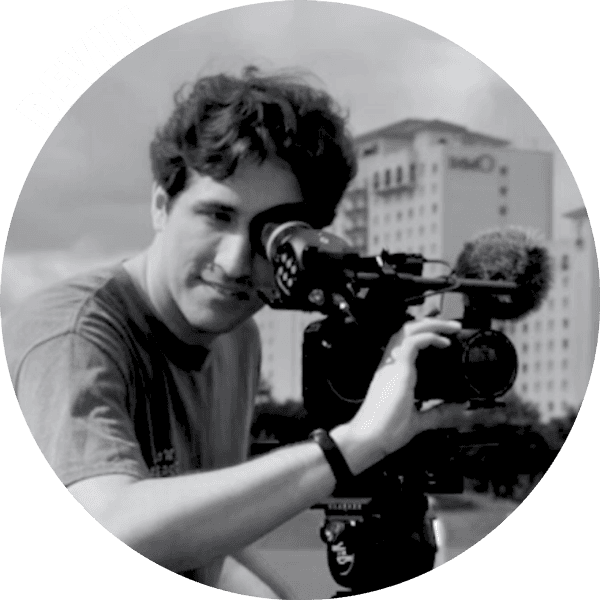 Photo of a cinematographer looking through a camera.