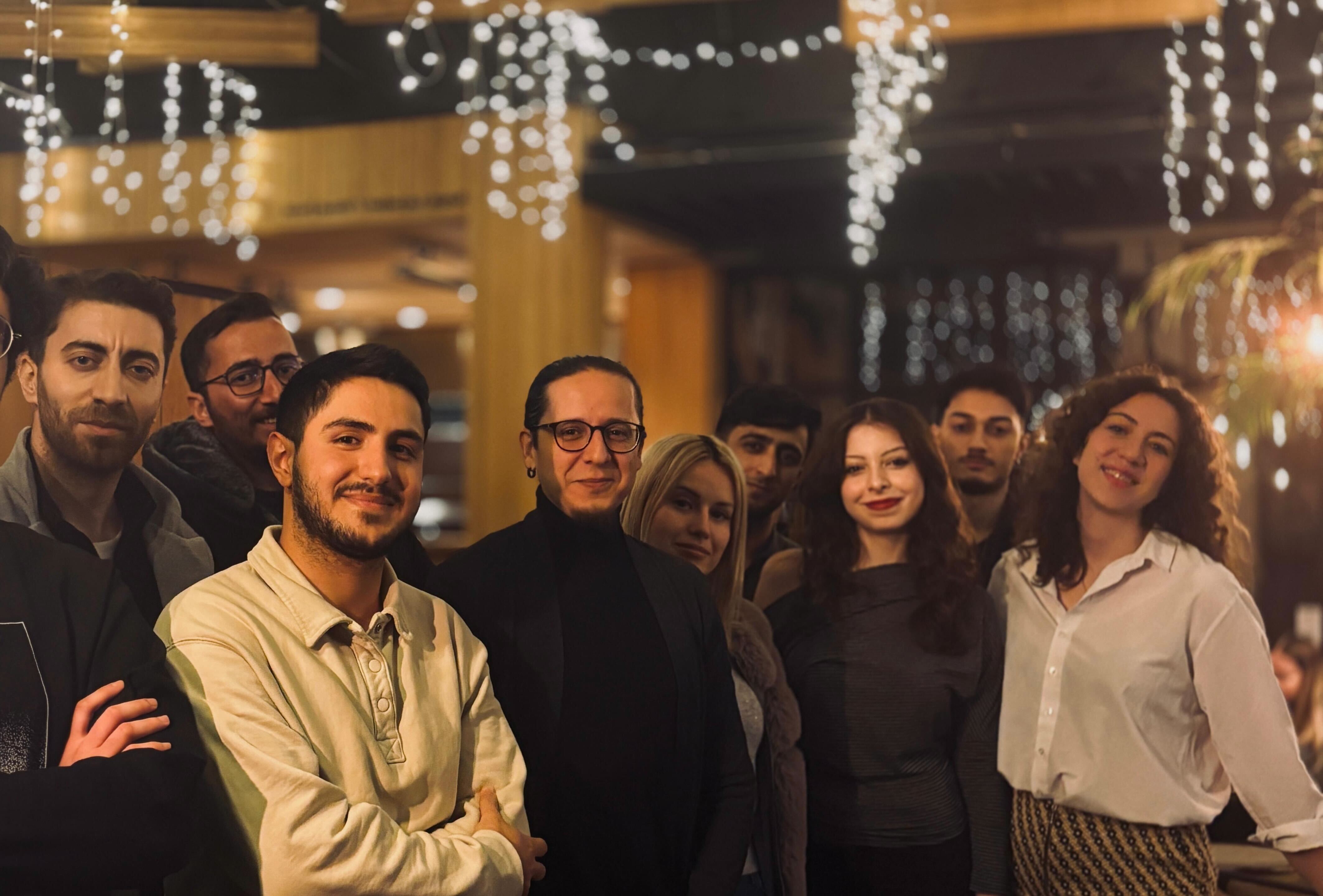 Two people working at a laptop