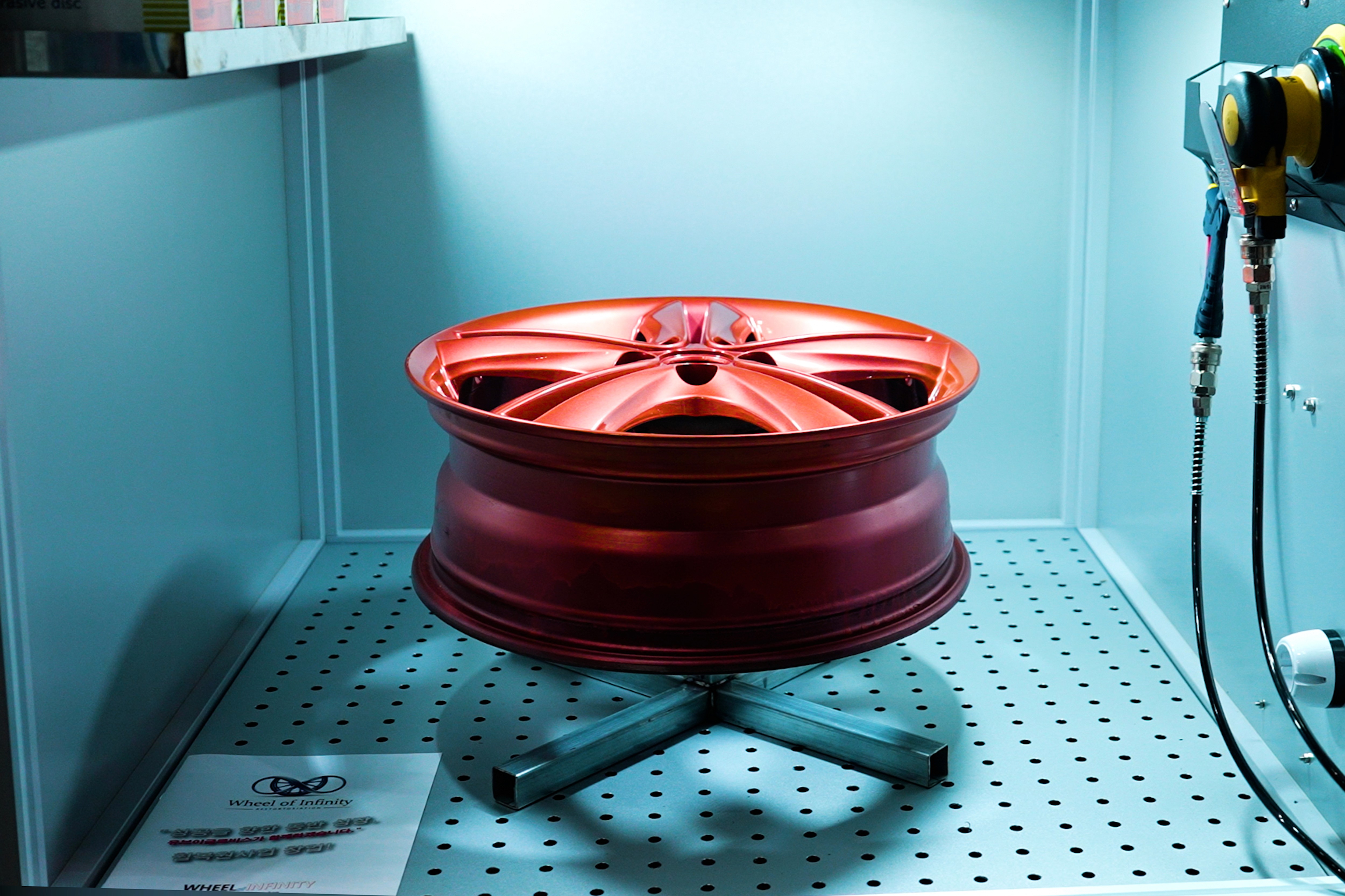 Modern kitchen with a wooden dining table, white chairs, and a hanging light fixture above.