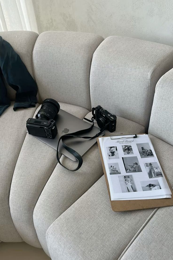 Minimalist facade with red window and striped awning on a white stucco wall under a clear blue sky.