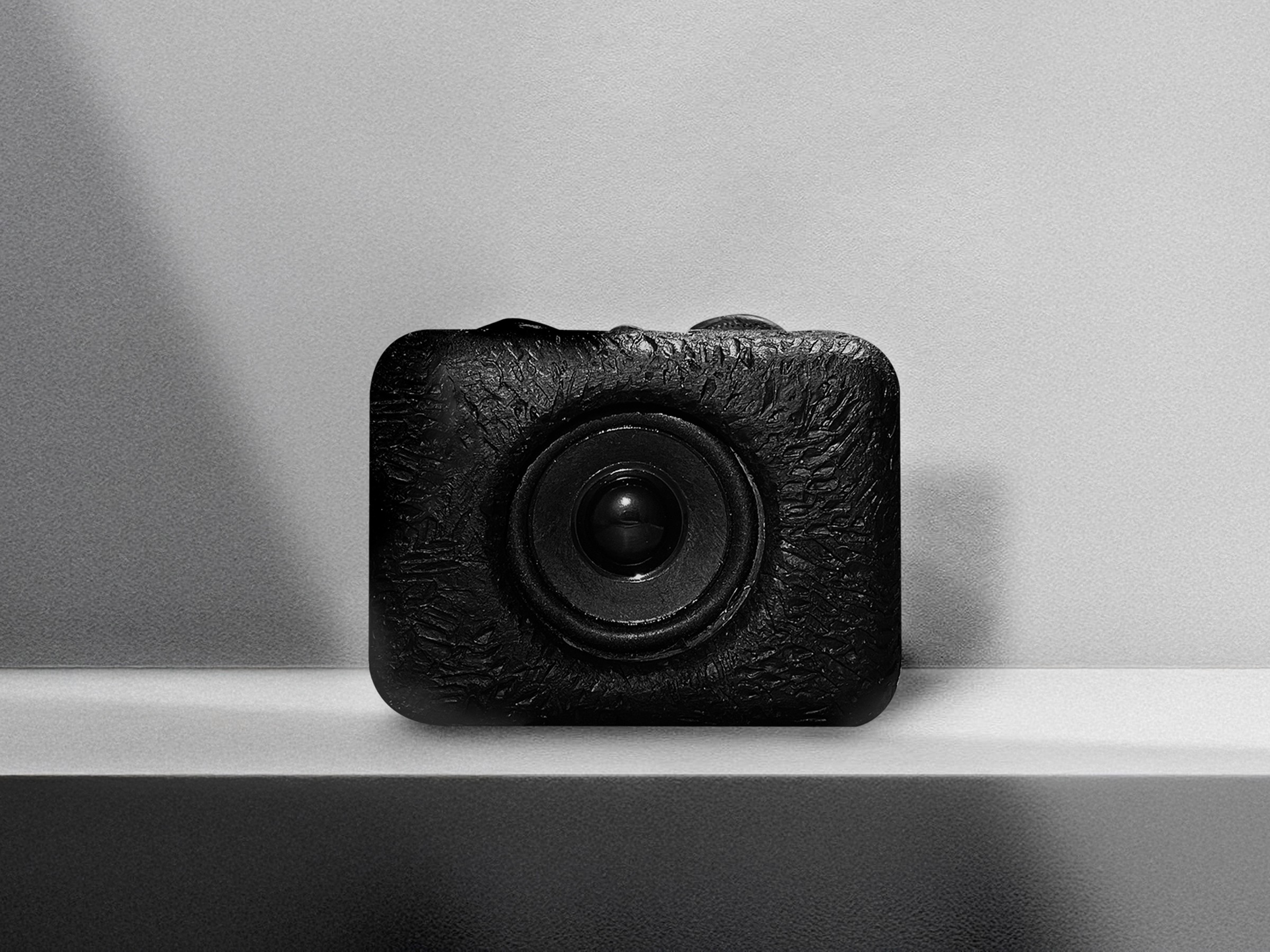 A rectangular shaped balck fm/am radio, forming rounded corners and a compact size for portability—minimal graytone background