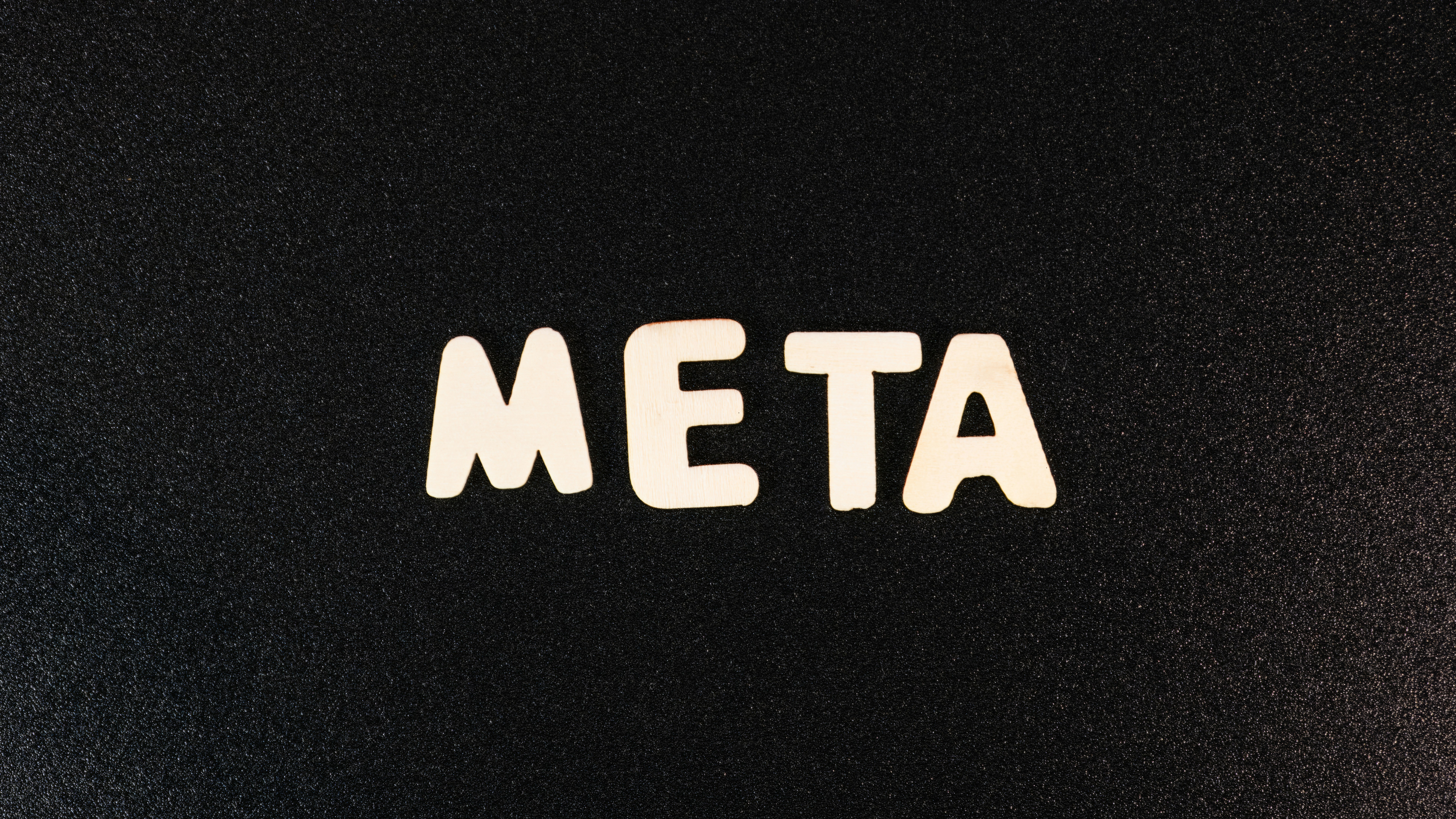 a close up of a black surface with white letters