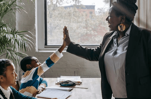 high-fives from mentor to student (Photo by: Katerina Holmes)