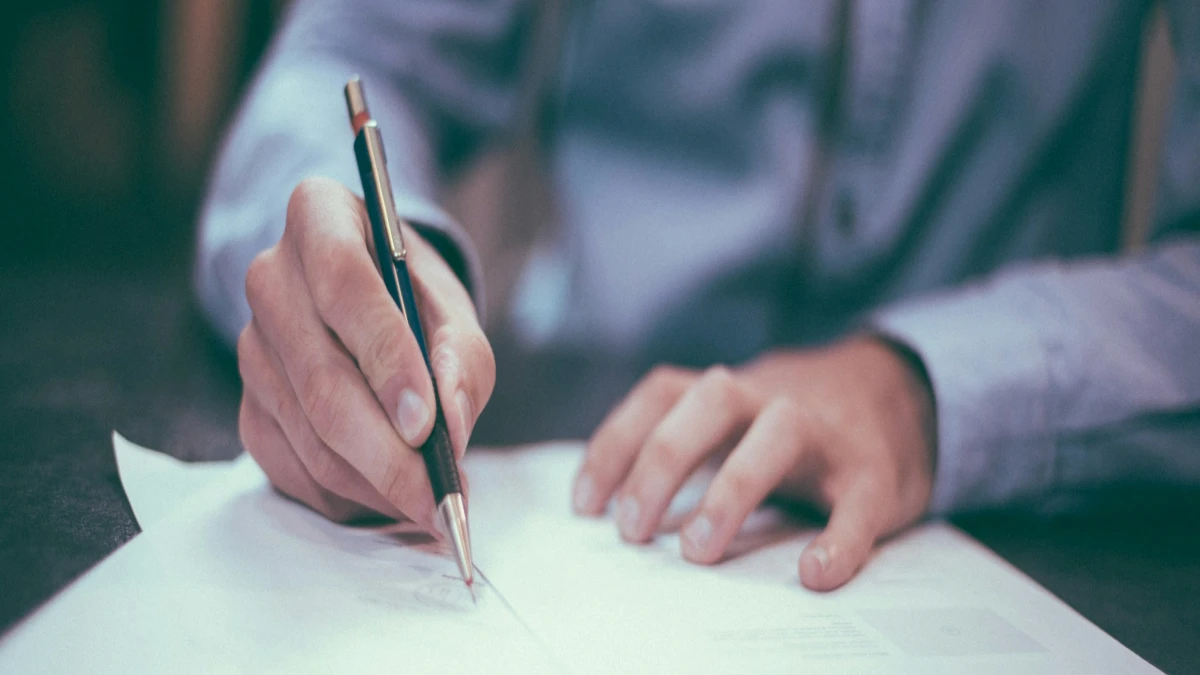 Man filling out equine insurance paperwork