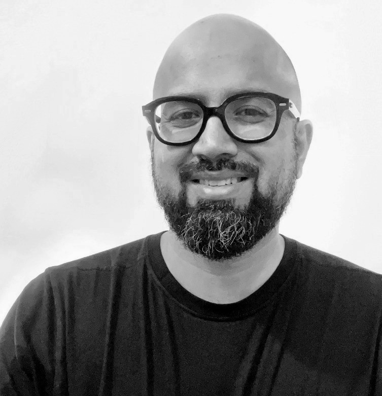 Woman working at desk with laptop and phone.