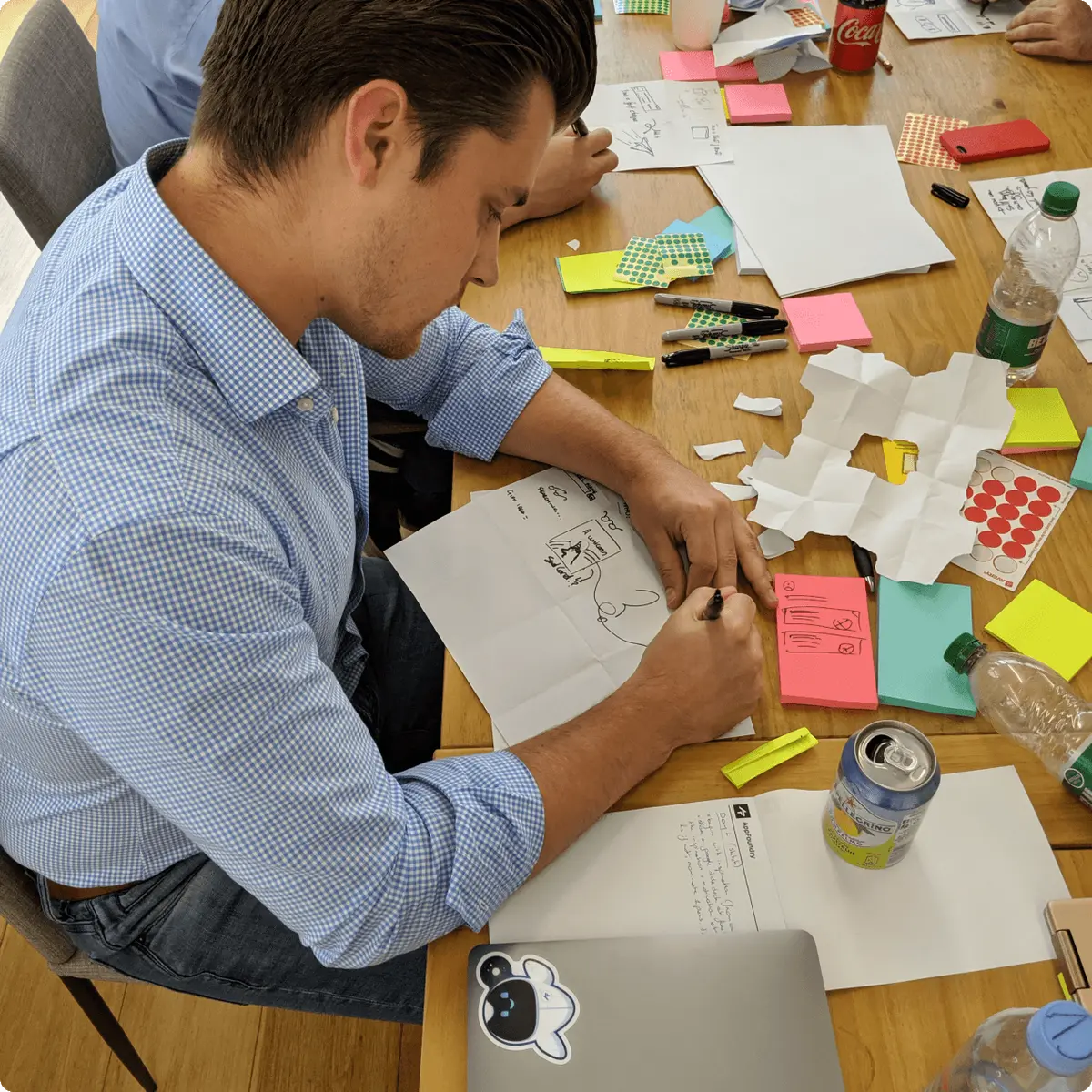 man drawing in ux workshop setting