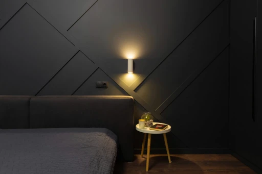 A bedroom with a bed and a night stand