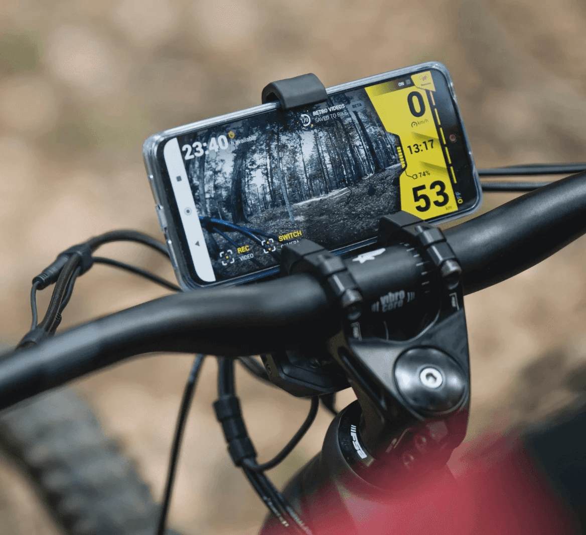 Smart phone clamped onto mountain bike handlebars.