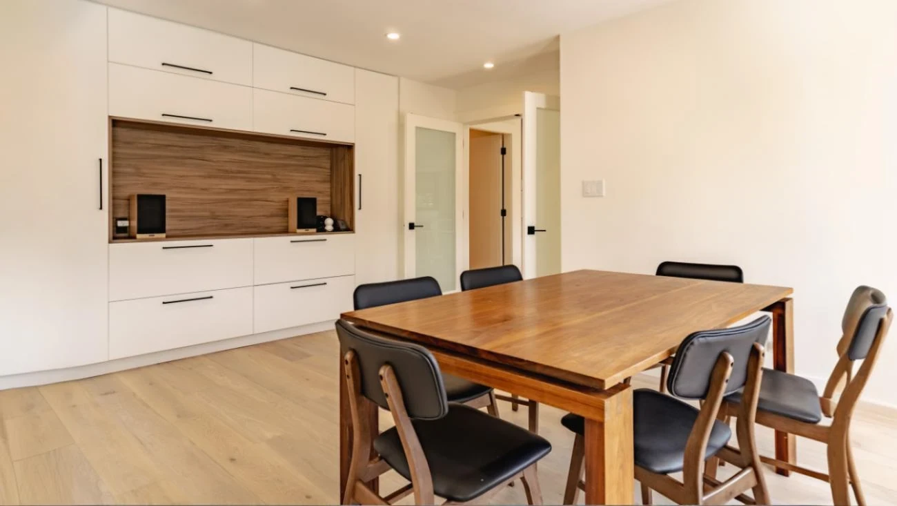 Contemporary dining room with custom built-in cabinetry, walnut wood accents, and modern dining furniture in Vancouver home