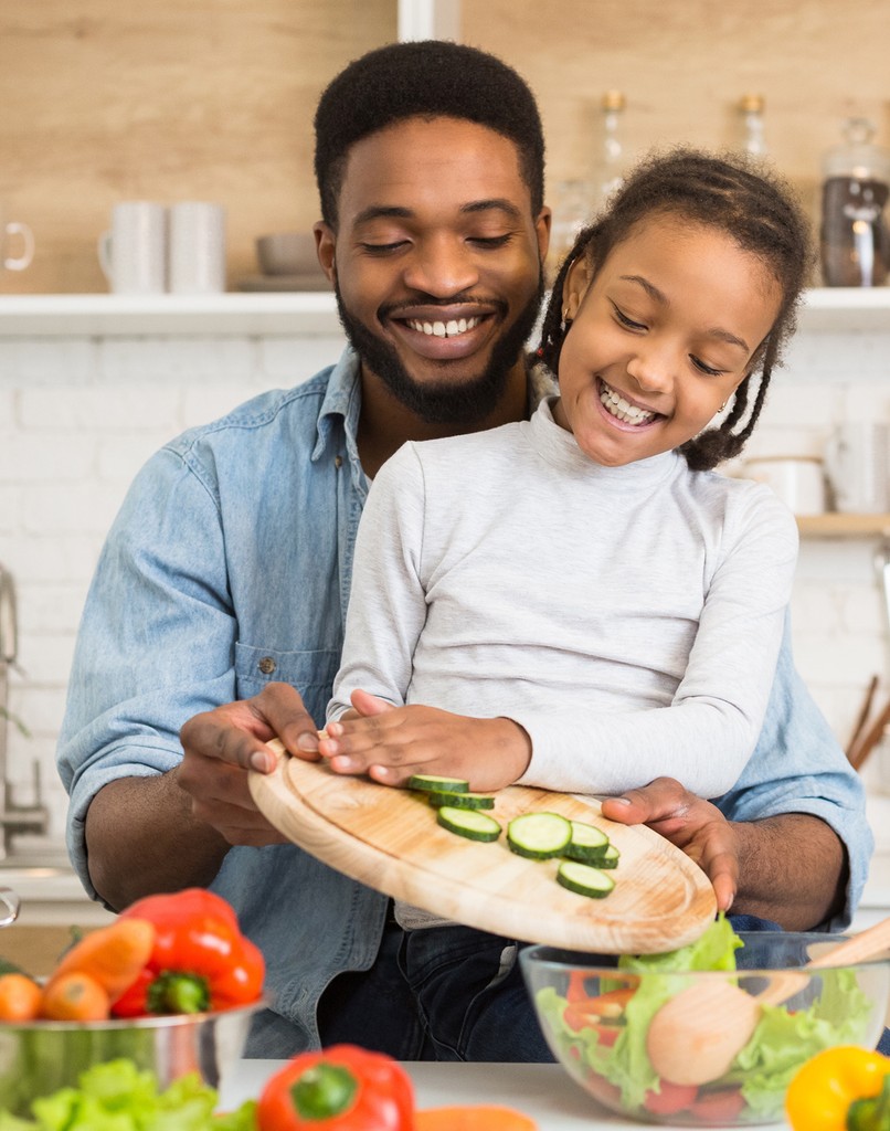 Coworkers preparing nutritious meal with recipe widget