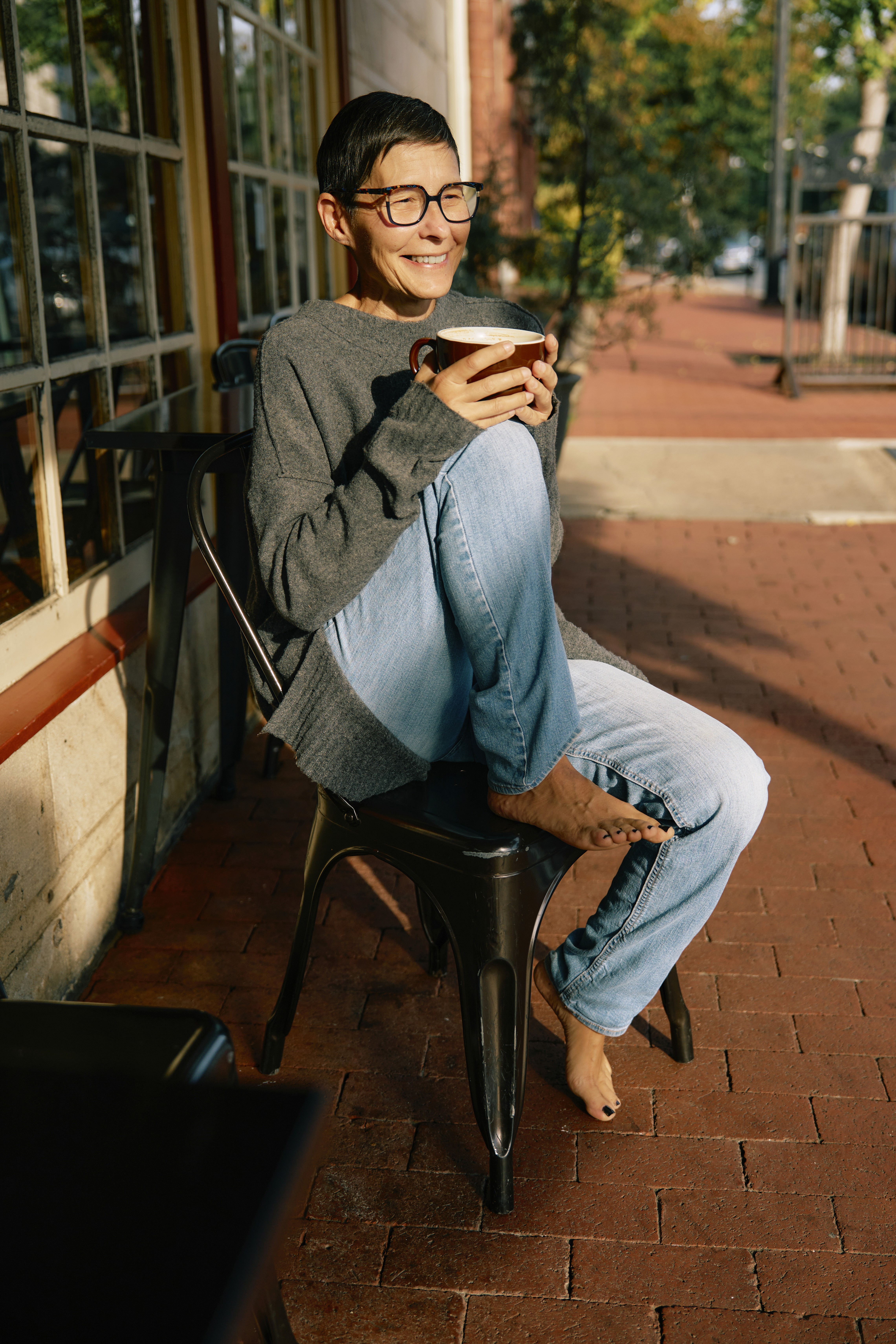 Tara, owner of Nurture, sips coffee to reflect. 