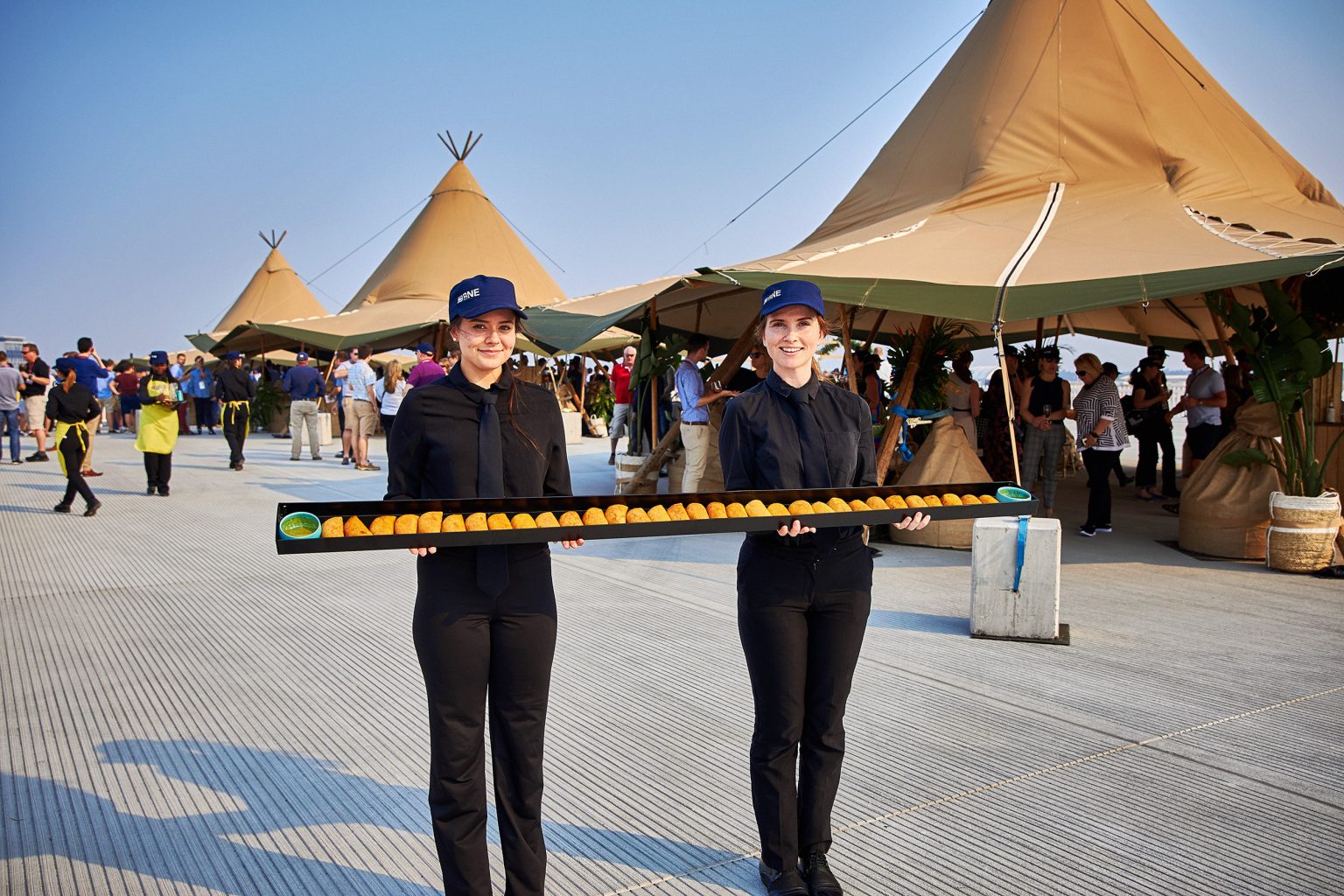Waitstaff taking canapes around on a long platter