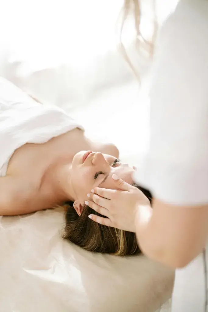 Relaxed woman receiving rejuvenating anti-aging facial focused on collagen stimulation and wrinkle reduction for a youthful glow.