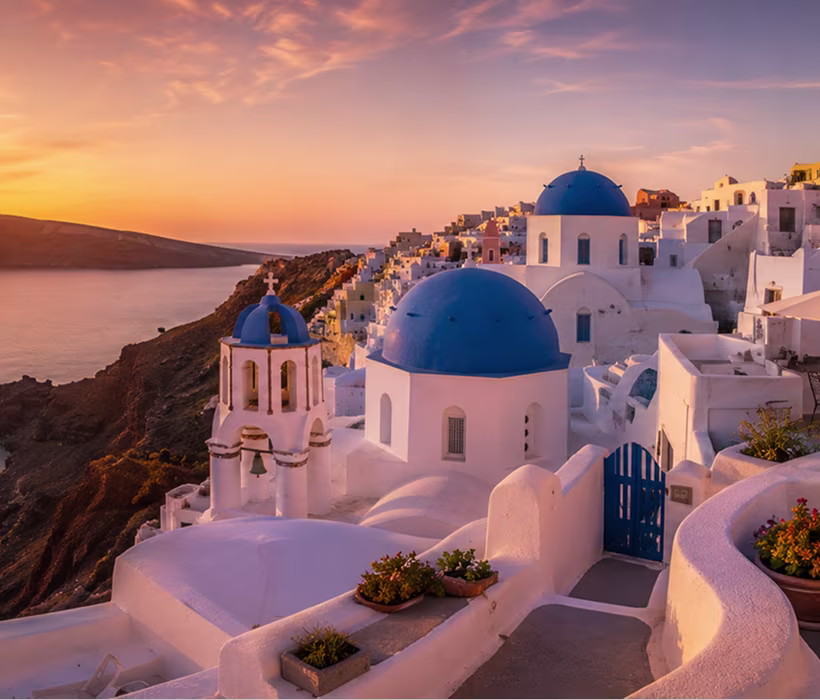 Couple watching sunset over Santorini caldera