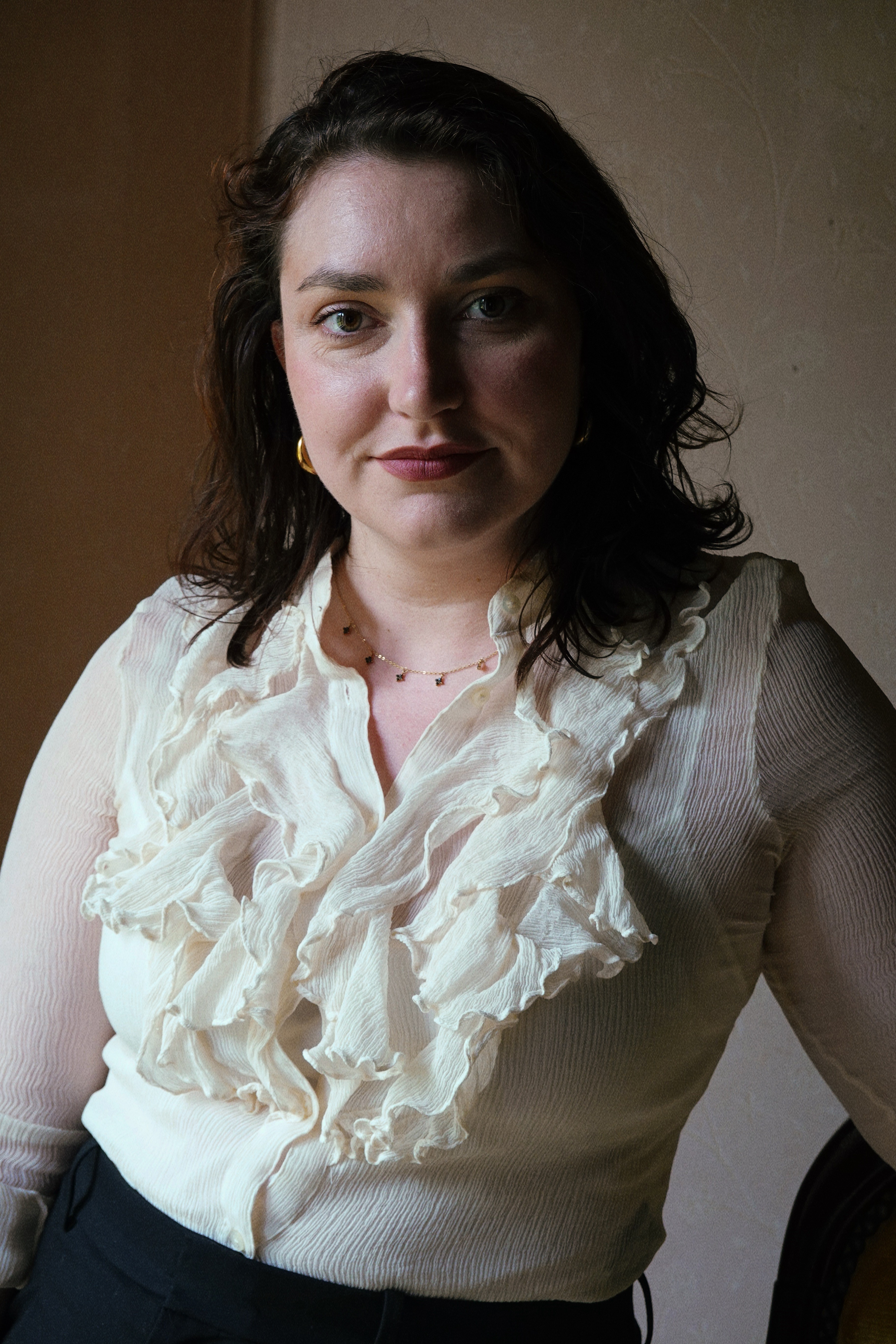 A woman sitting in a photo studio