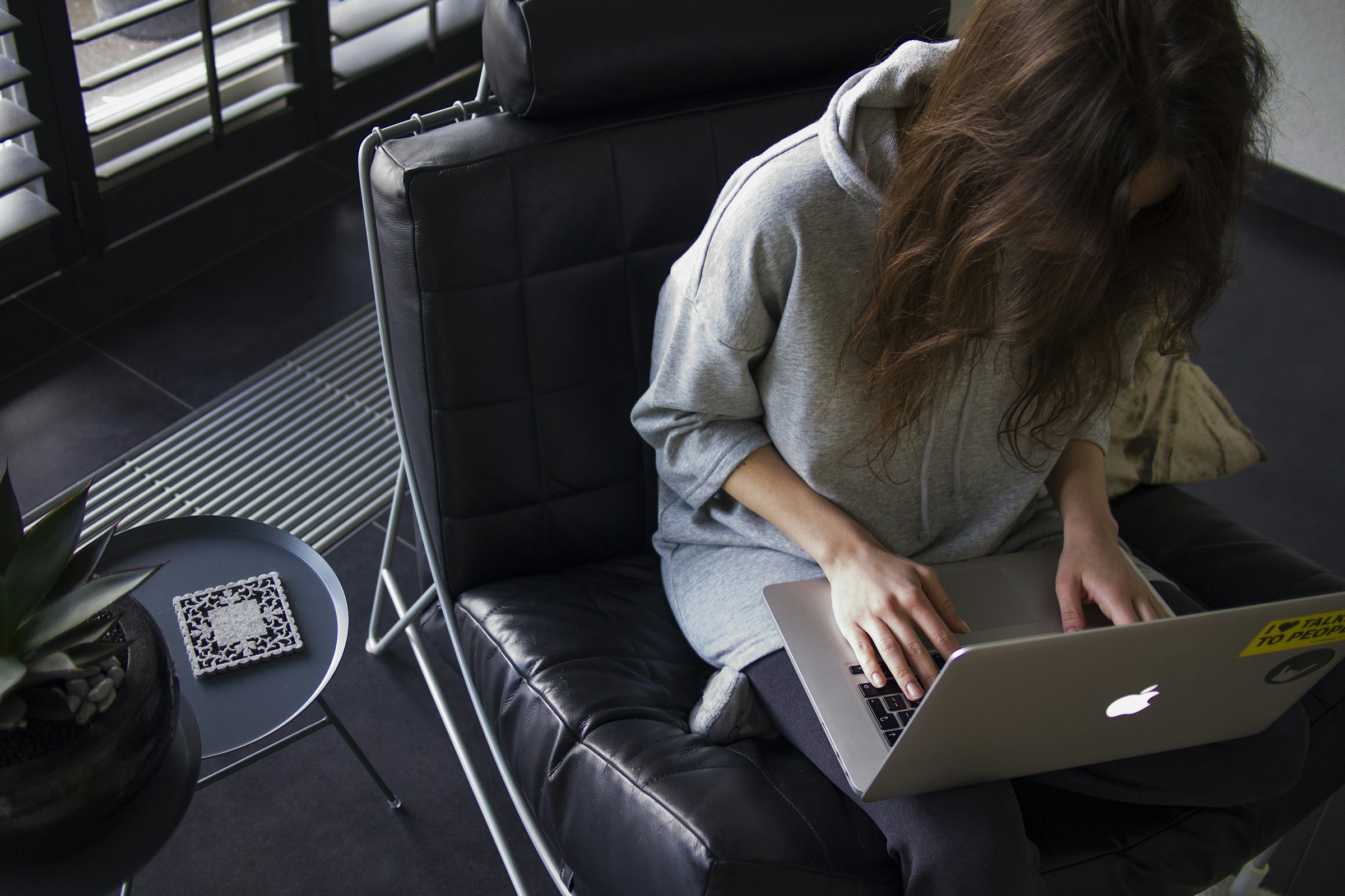 woman sitting alone and doing research - Shopify Store Optimization 