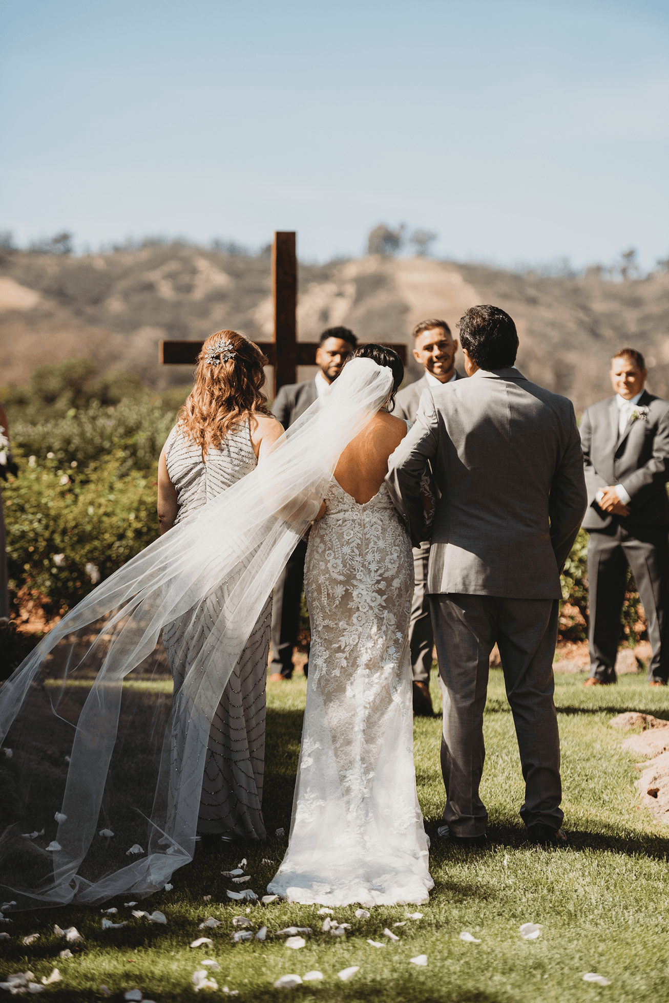 Flat lay wedding details with bouquet, rings, and sparkling bridal heels