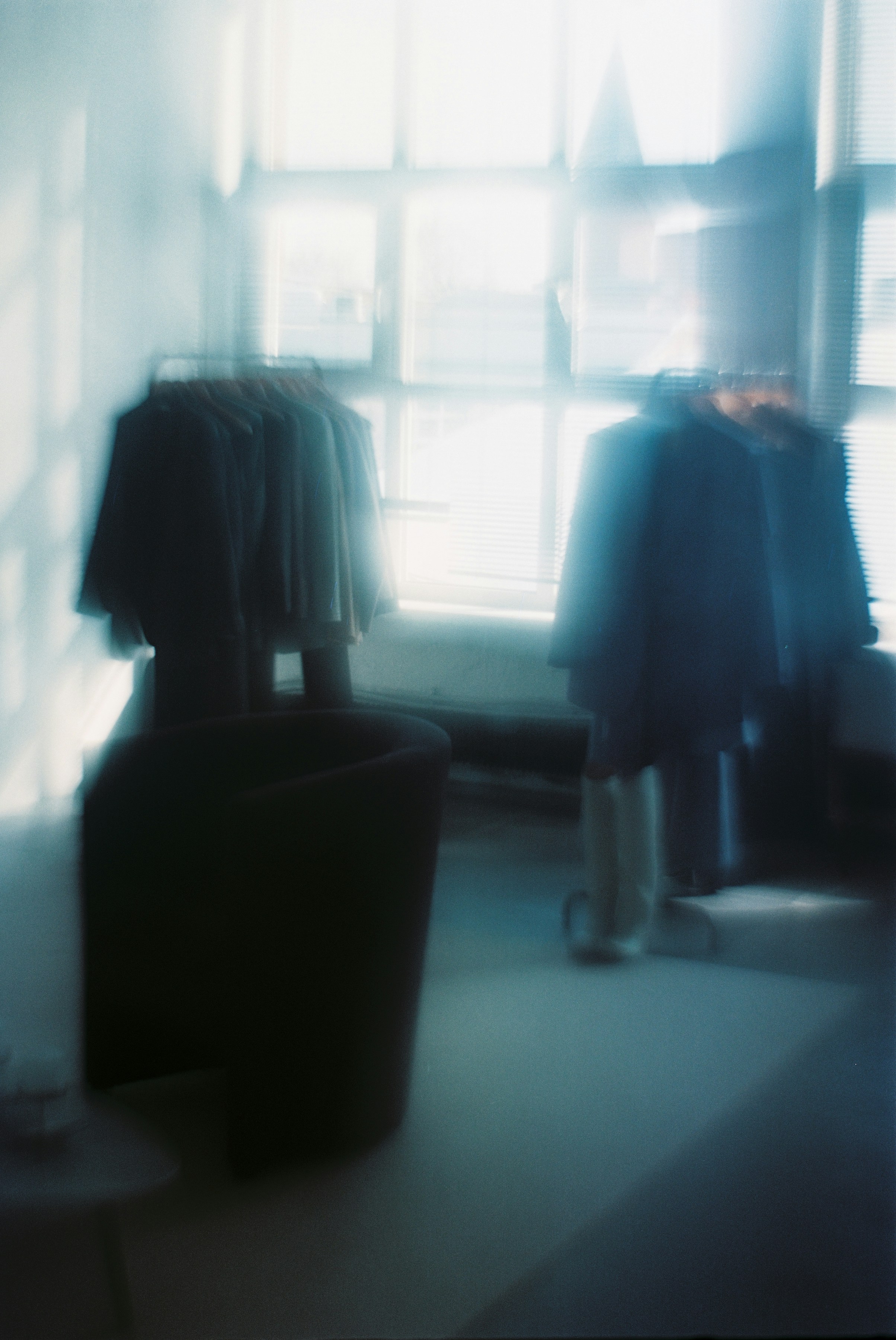 a blurry photo of a person standing in front of a window