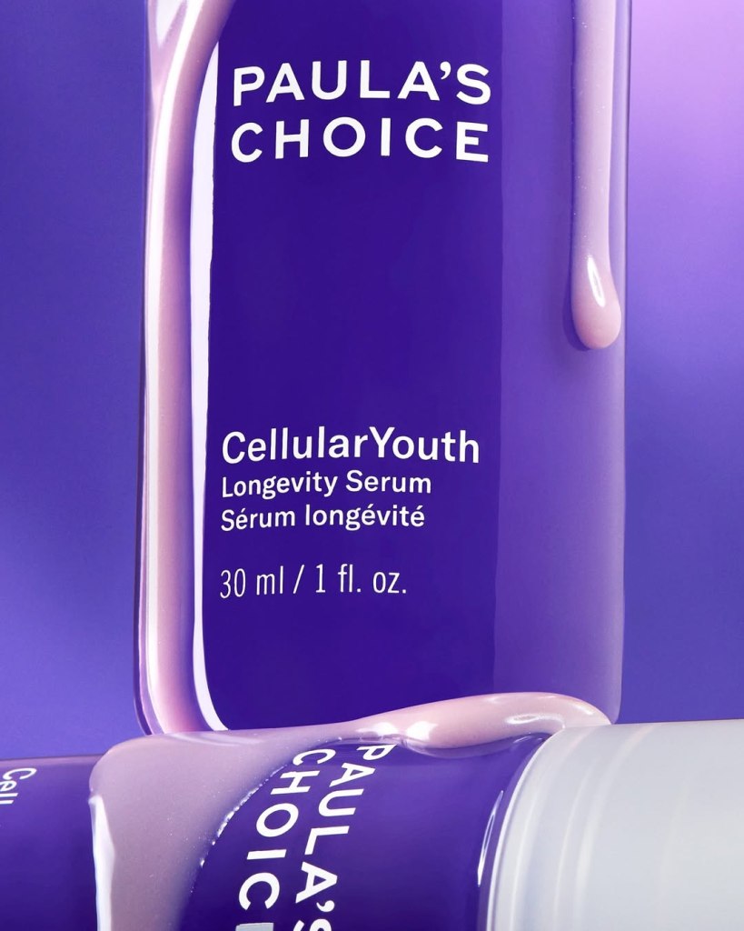 Product image of Paula's Choice CellularYouth Longevity Serum, featuring a purple bottle with a silky texture drizzling down.