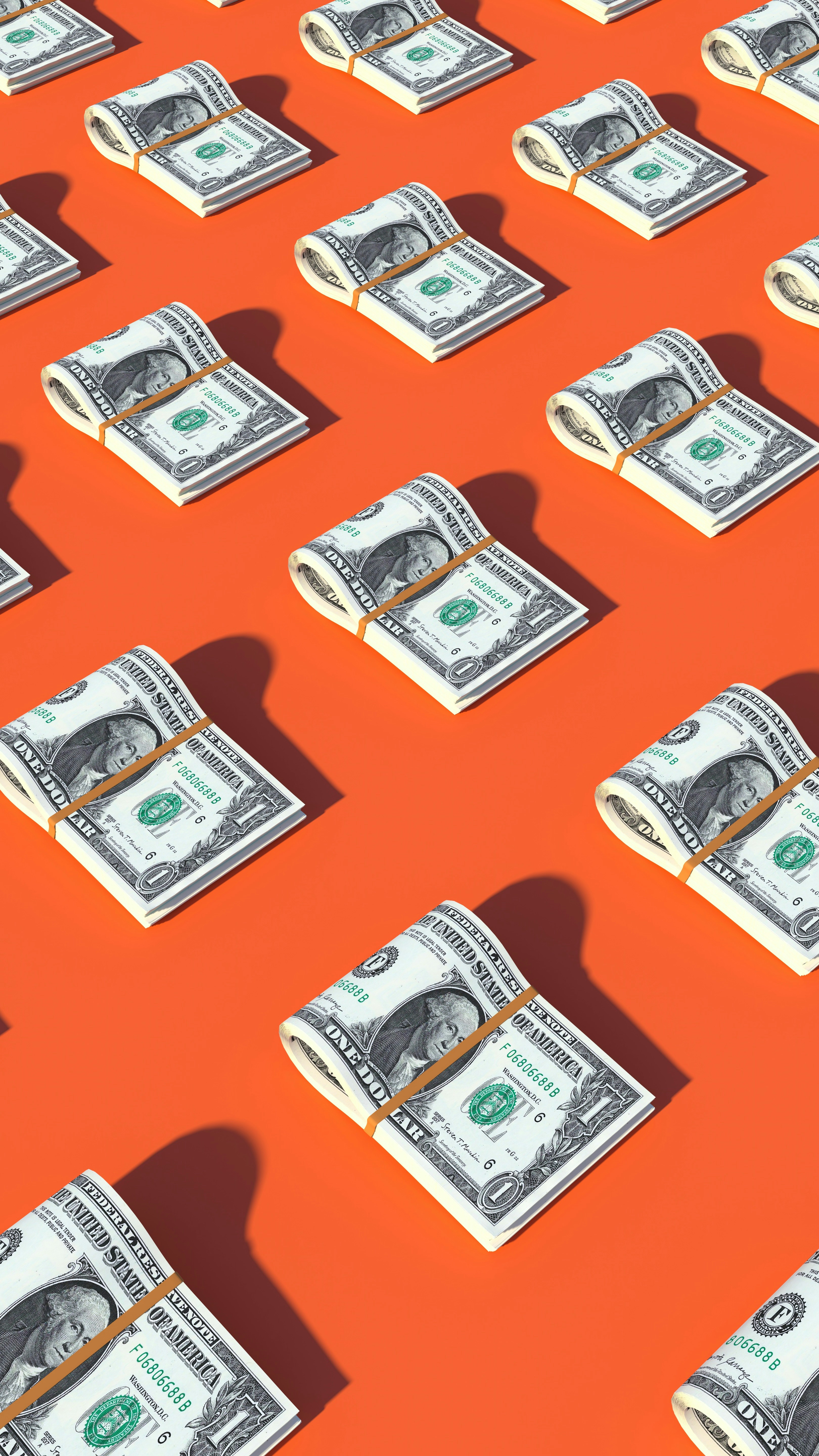 Repeating pattern of folded US one-dollar bill stacks held with rubber bands, arranged in a grid on a bright orange background.