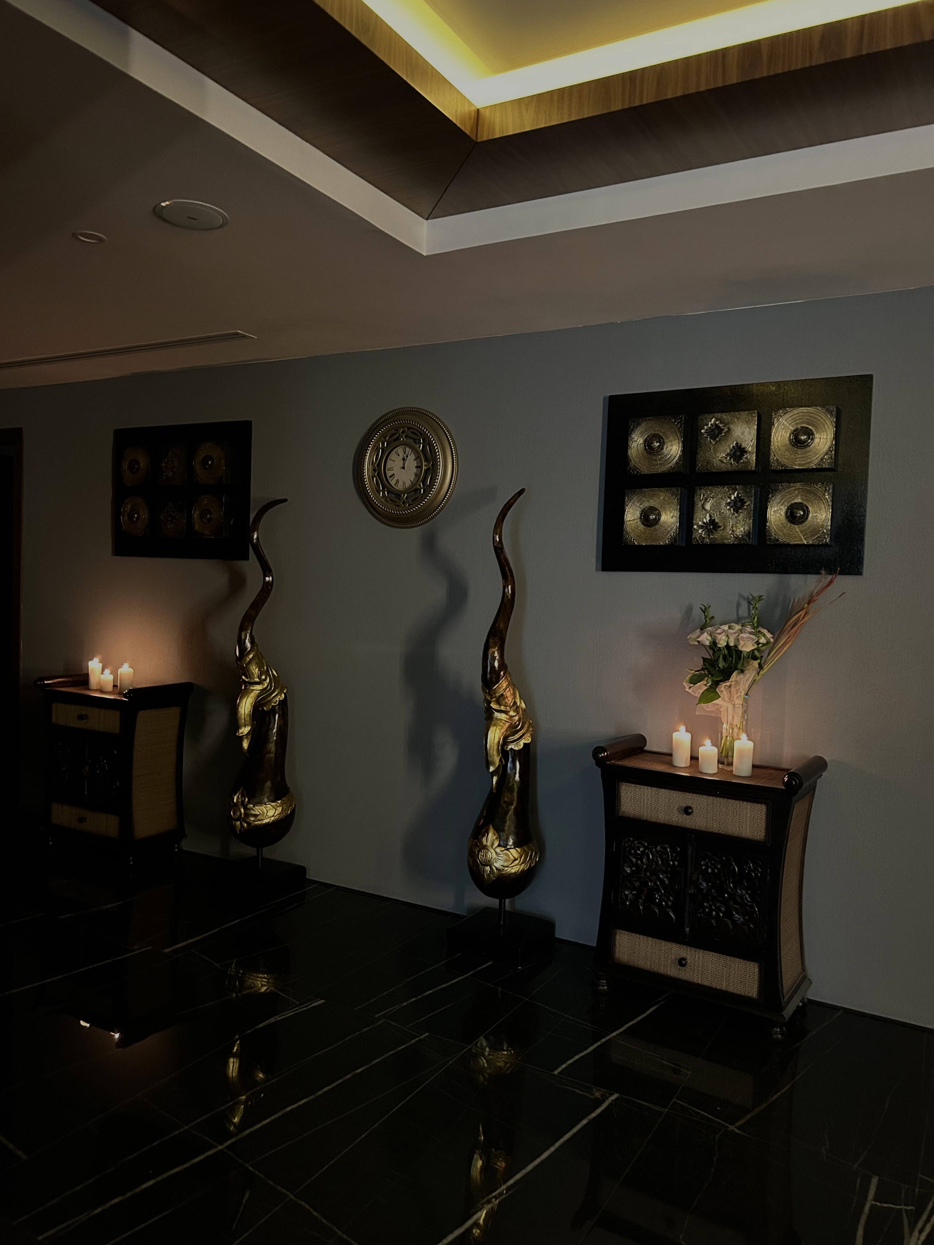 A cozy scene with warm sunlight casting stripes, featuring a potted plant and soft towels on a window sill.