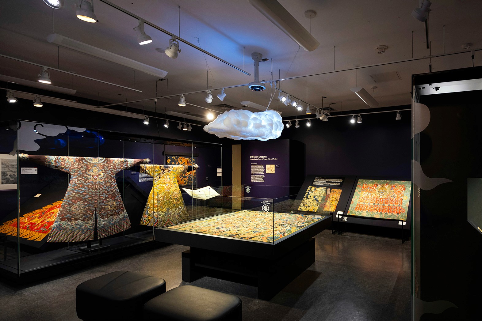 a museum exhibit that has ancient chinese textiles and a cloud that lights up in the middle of it 