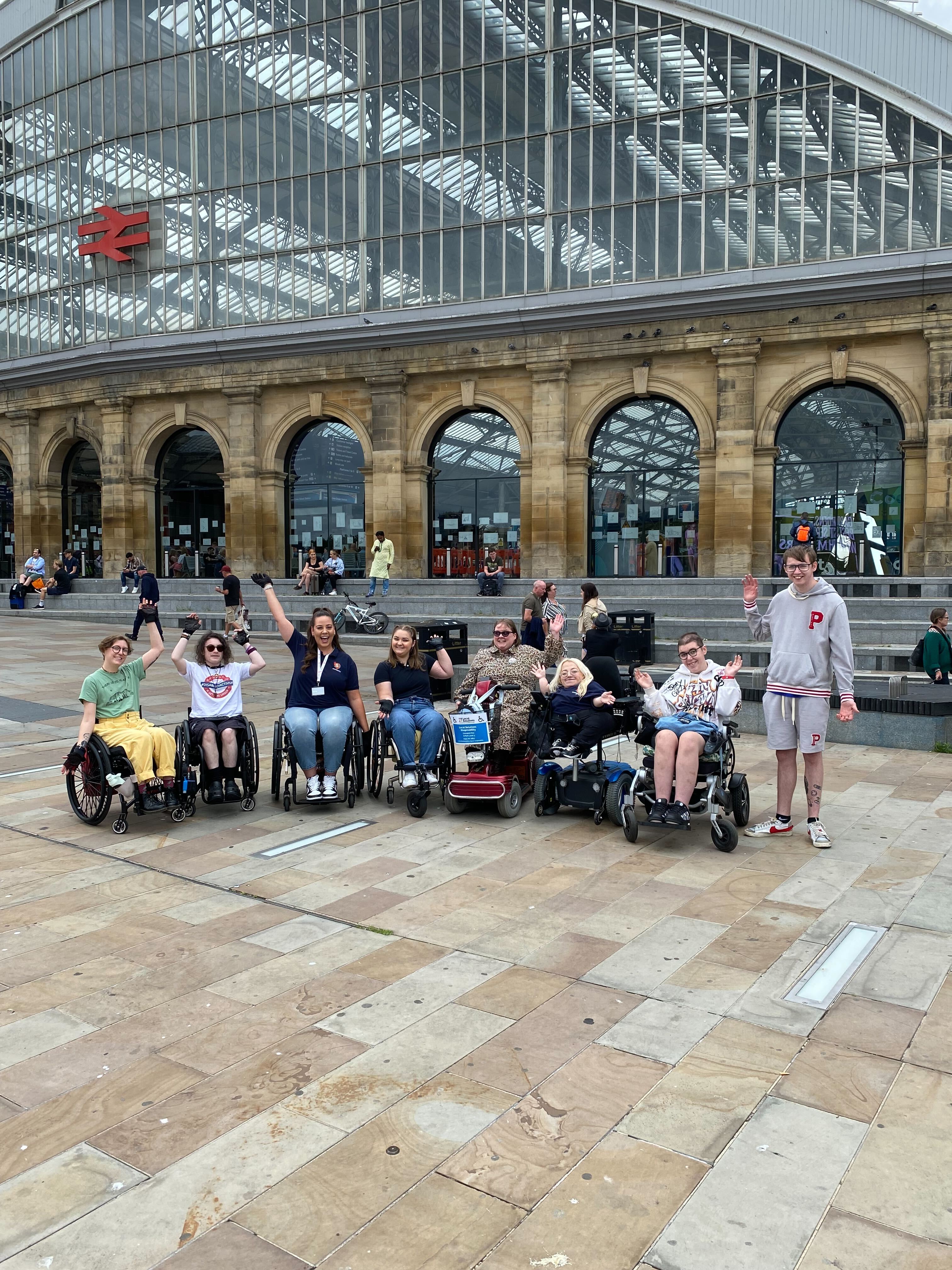 Wheelchair users and non-Disabled allies celebrating on a Sociability community day.