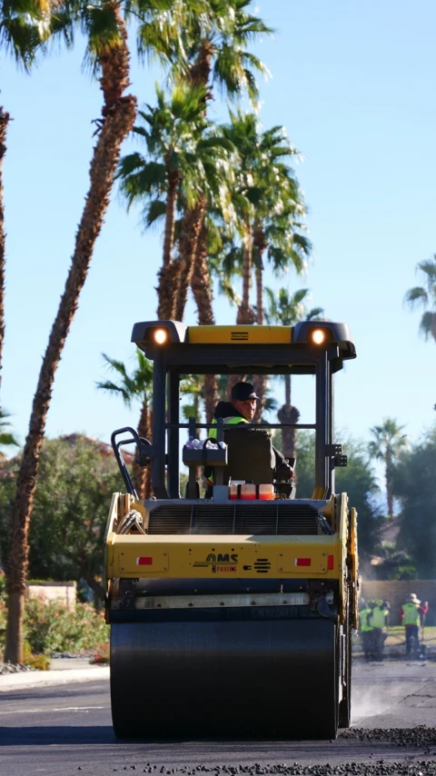 Roller compacting freshly paved asphalt overlay