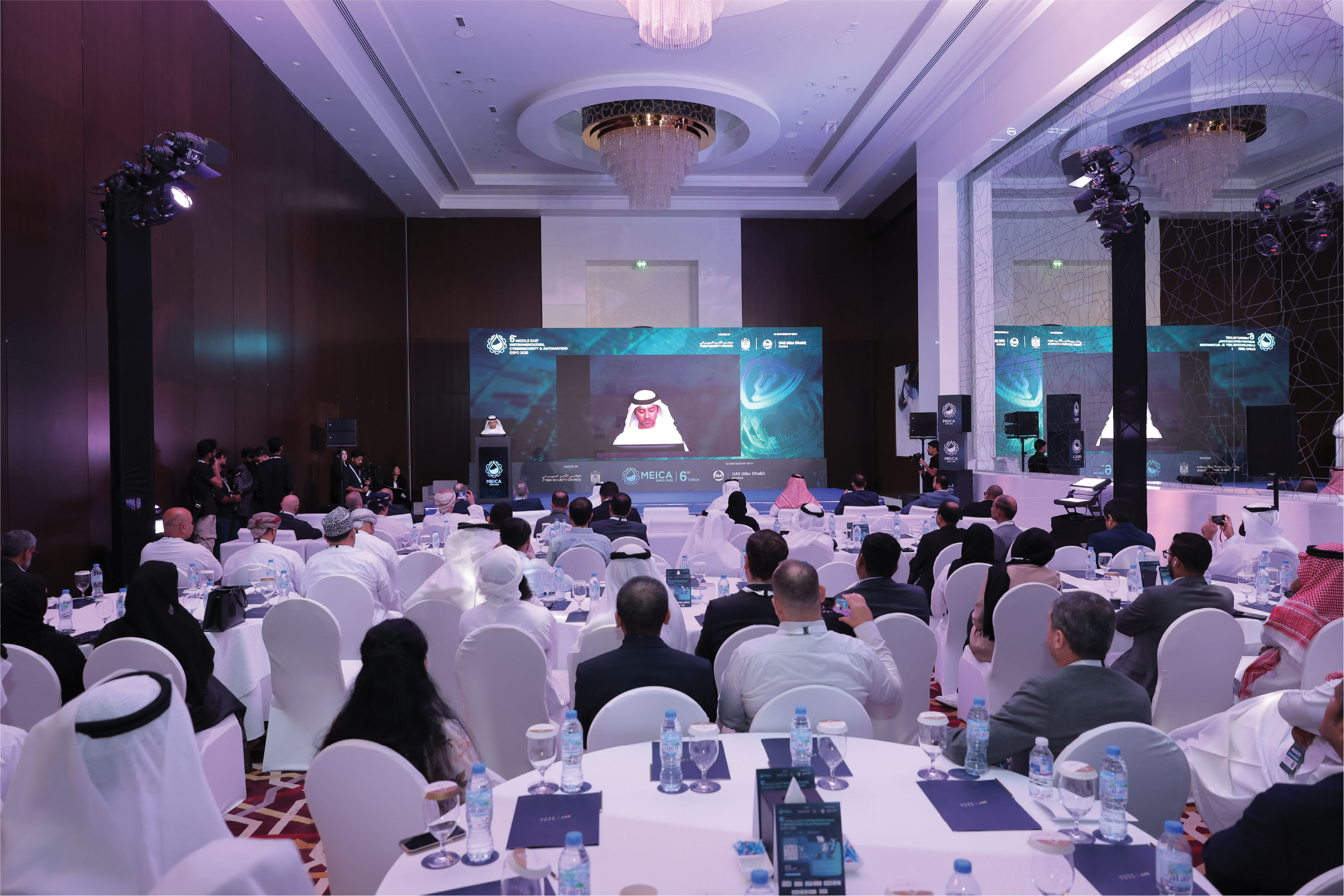 Man in VR headset interacts with green holographic code displayed on a curved screen.