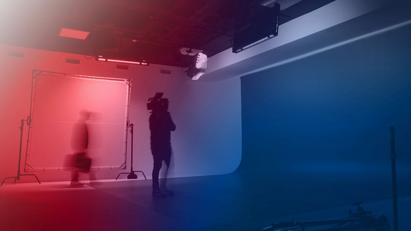 WTADS motion blurred photographers filming on interio set with red blue gradient. 