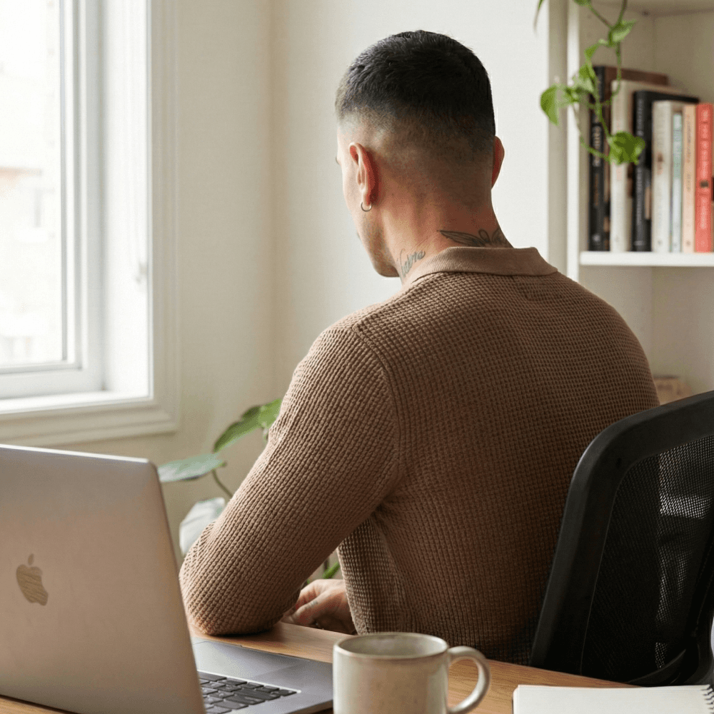 Alberto in the office with his back towards the camera