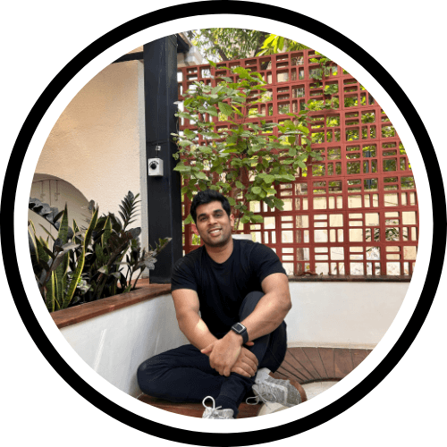 Portrait of medium brown and white dog on pink background