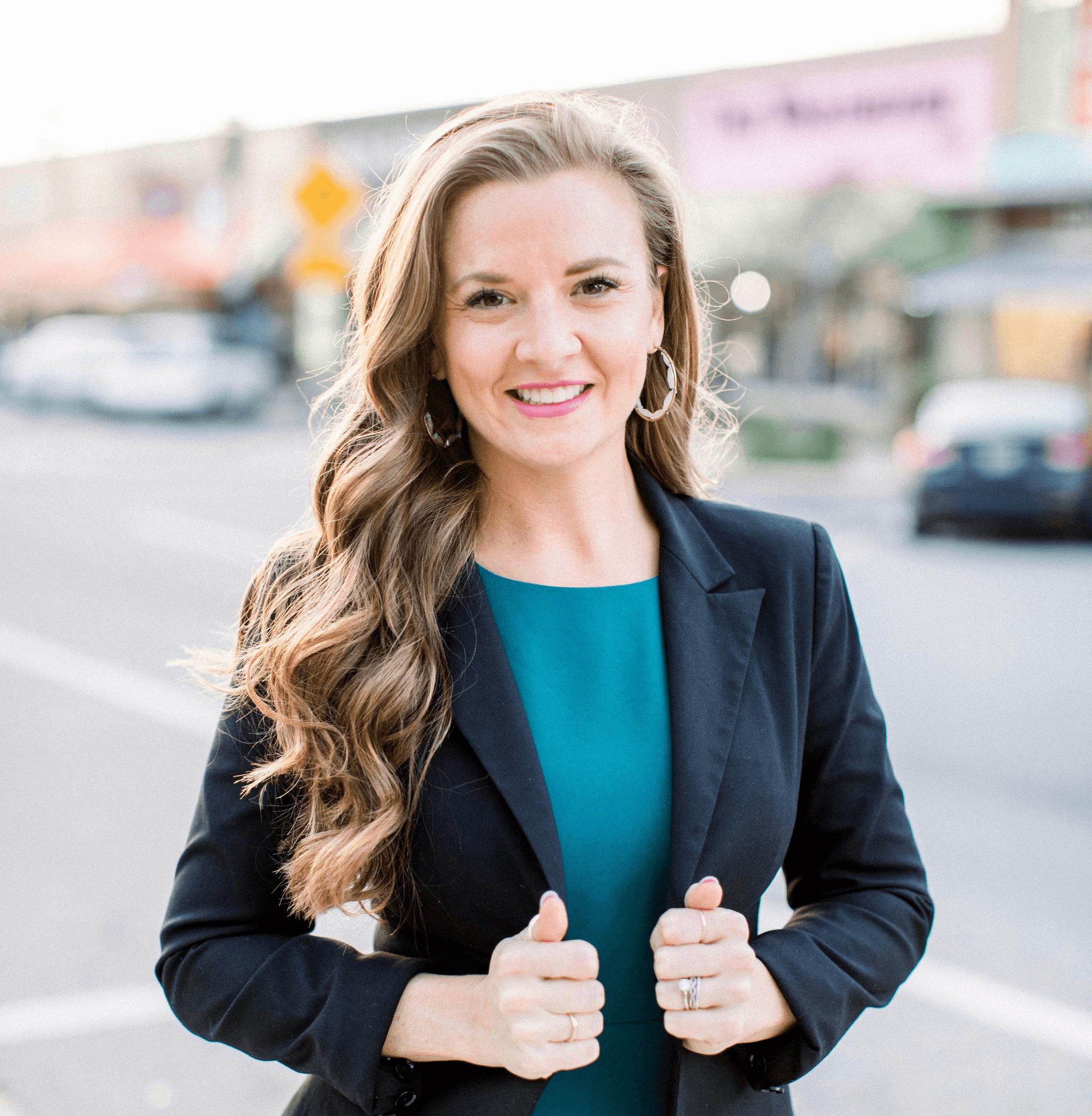 woman in black blazer smiling