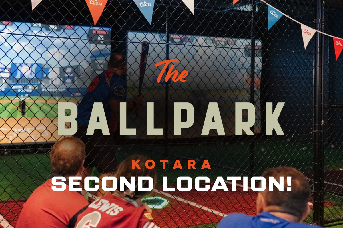 HitTrax Suite batting cage at Kotara with netted hitting lane, turf floor, and simulator screen.