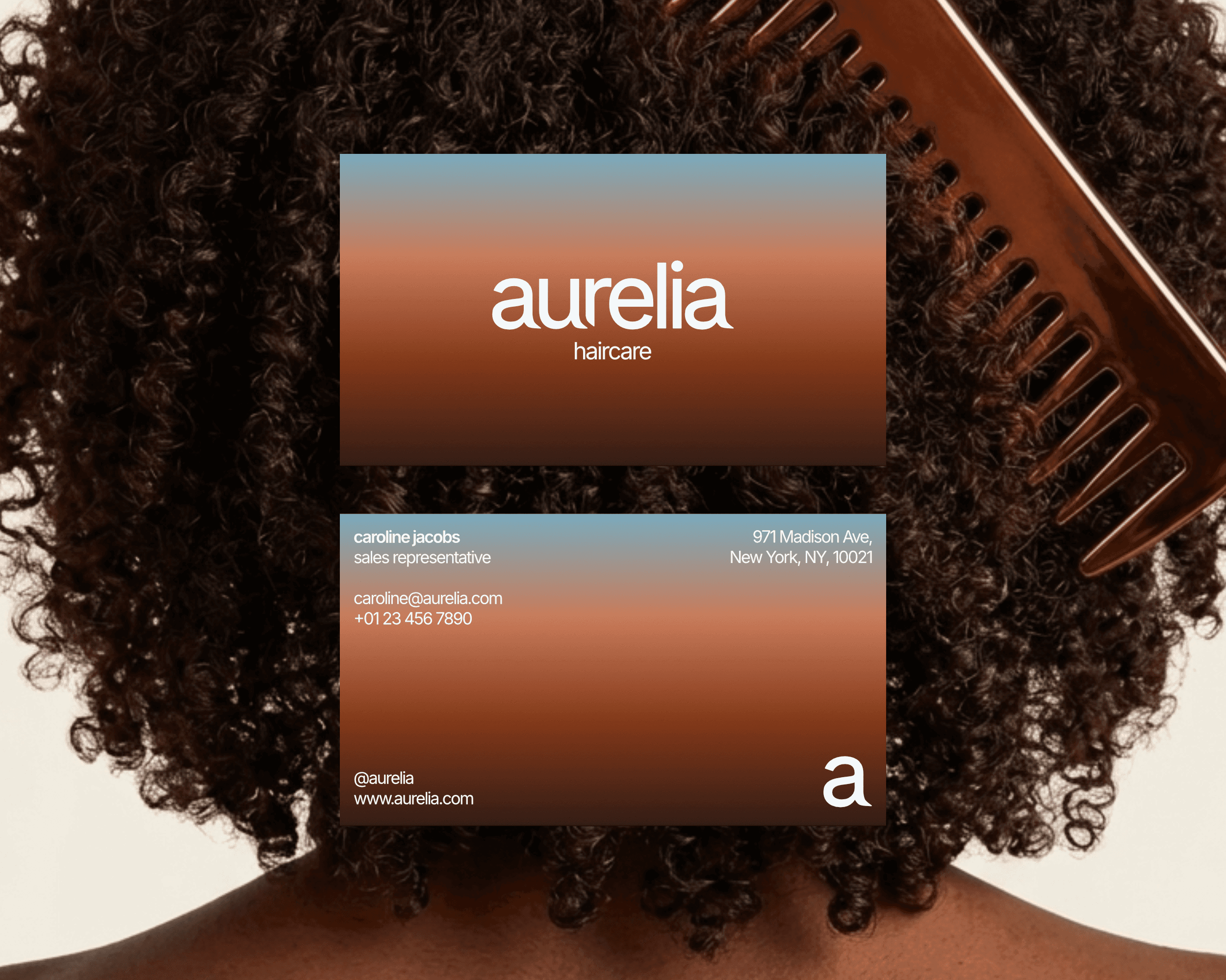 Mockups of the Aurelia Haircare business card design on top of an image of the back of a curly-haired woman's head. The business cards feature a simple design with a blue and brown gradient.