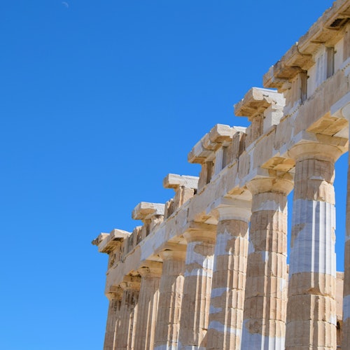 湛蓝晴空下，一座古典希腊建筑的古老石柱。