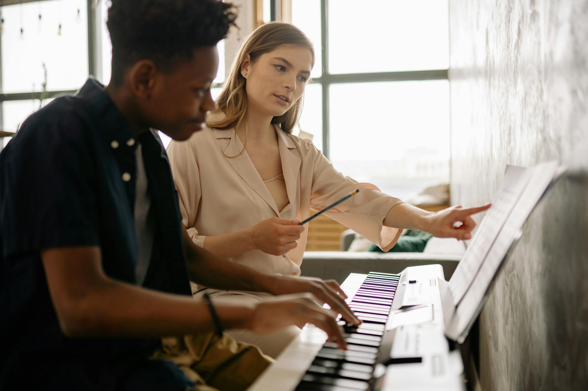 Diverse university students practicing contemporary singing techniques together in a bright, modern rehearsal hall.