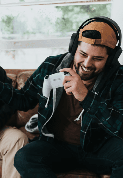 a group of men sitting on a couch and holding game controllers