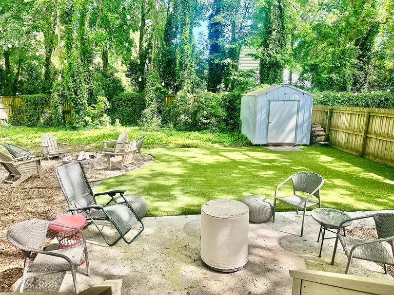 Patio loungers and turf beside the backyard storage shed