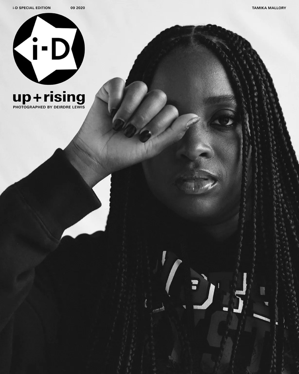 Black and white i-D magazine cover of Tamika Mallory, posing with one hand partially covering her eye