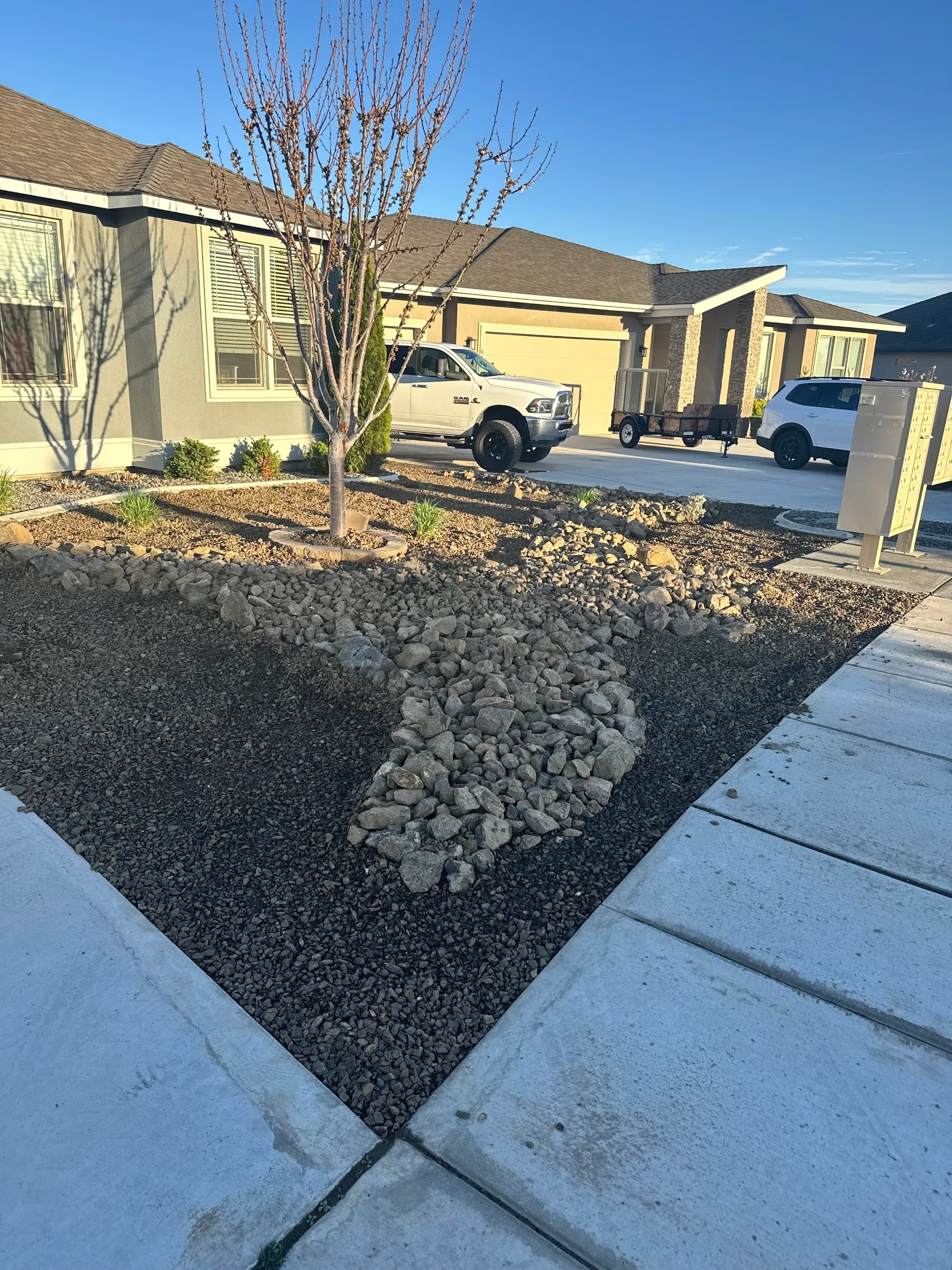 Dry Creek with rip rap and boulders in west richland Washington Front yard landscaping.