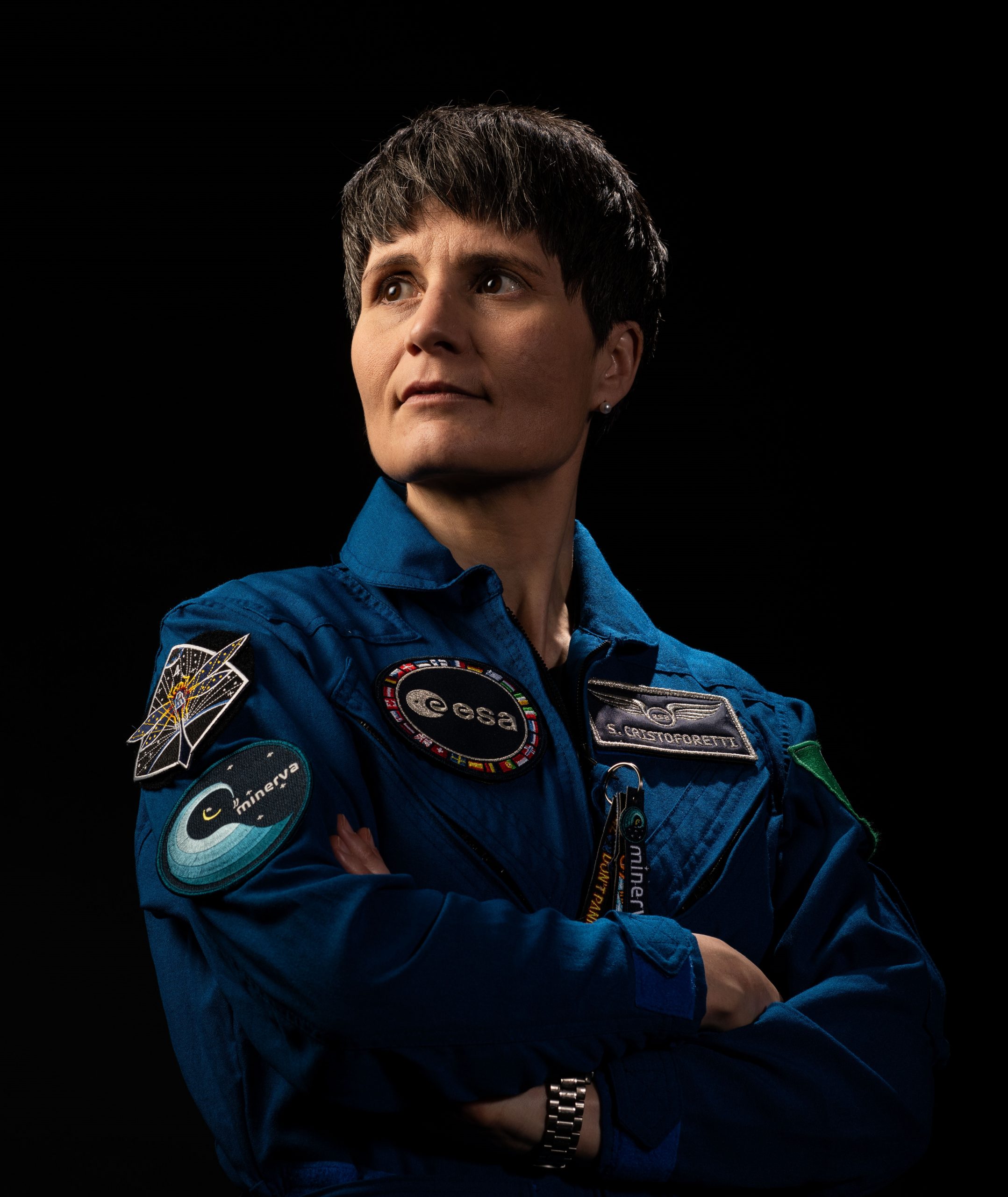 muscular man in glasses smiling and folding arms